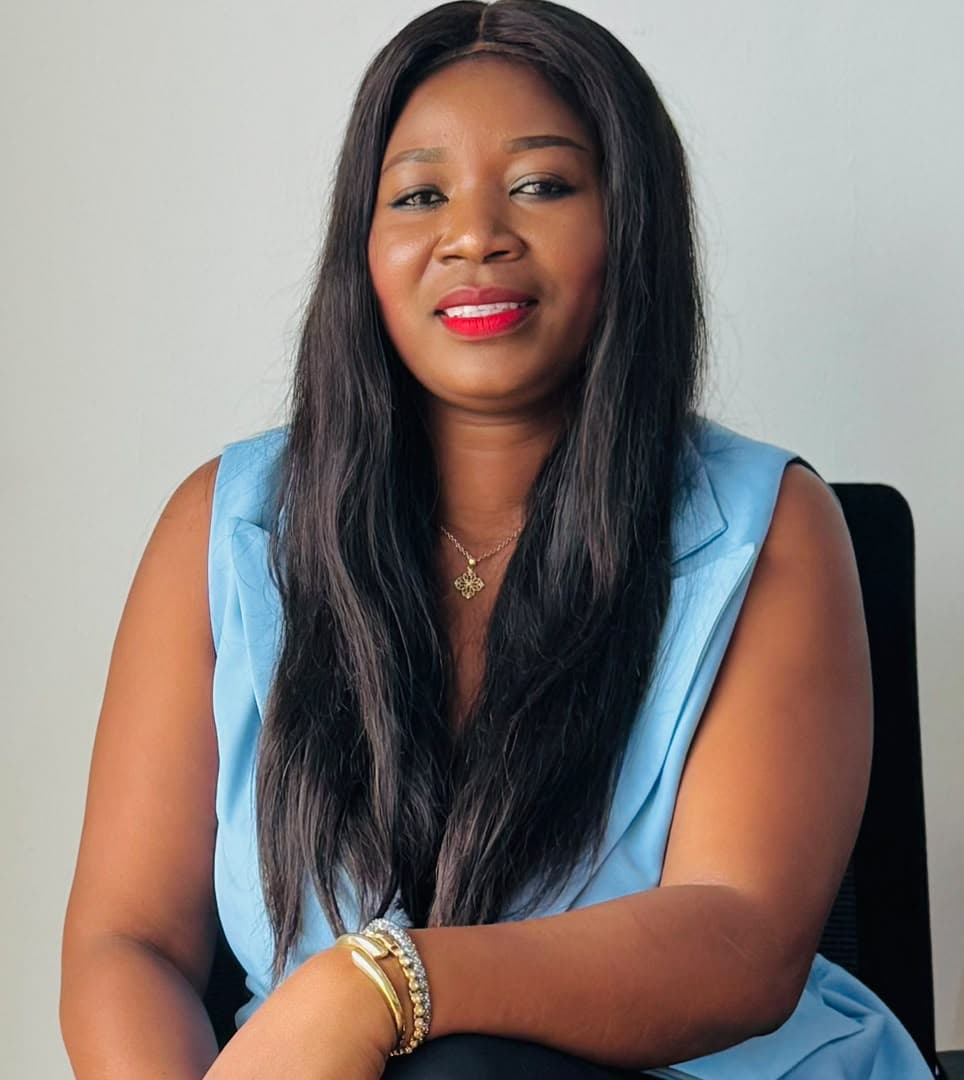 Malorfa in a light blue top, studio portrait