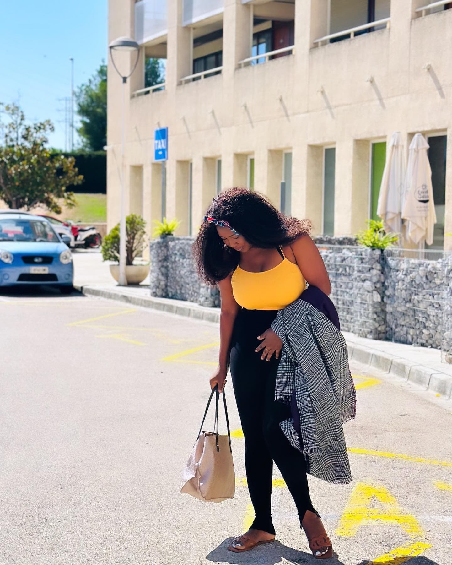 Malorfa in a yellow top on a sunny city street