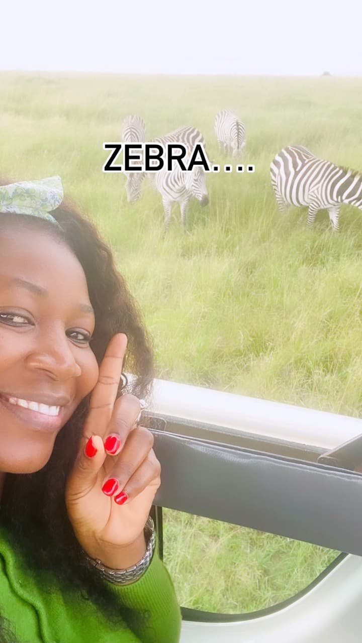 Malorfa on safari with zebras in the background