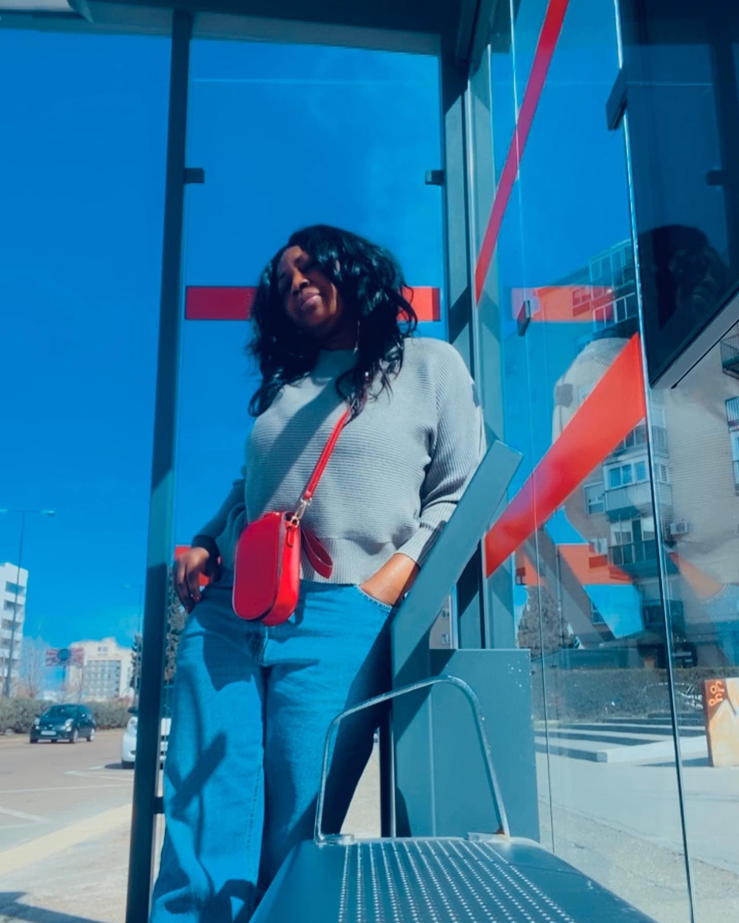 Malorfa with a red bag in an urban transit setting